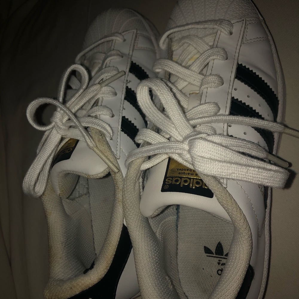 white and black stripped superstar adidas